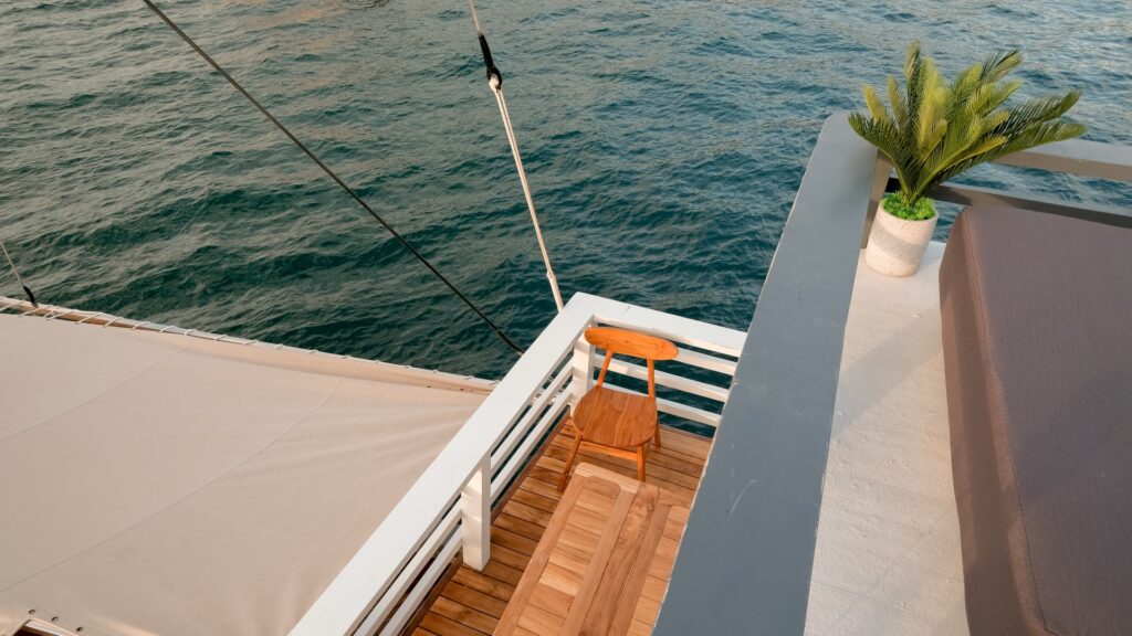 Overhead view of a small side deck platform with rope railing over the water