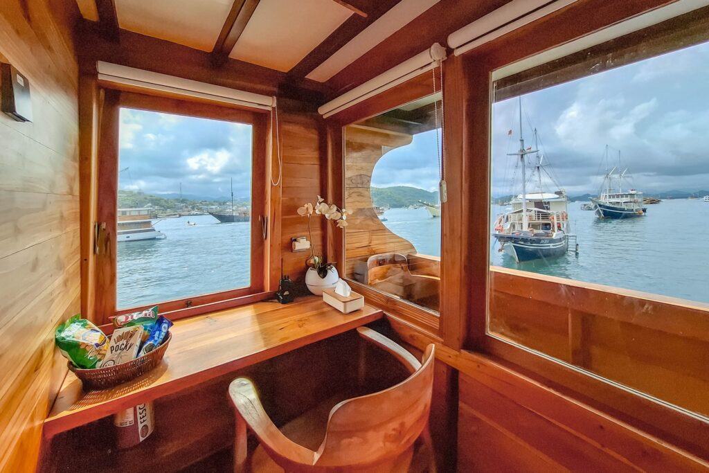 Master Suite wooden desk and chair beside a window with harbor view