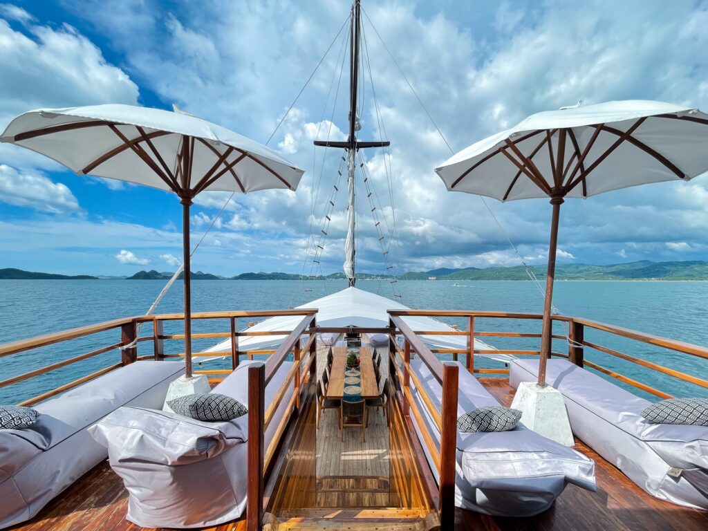 Upper deck view with sun loungers and umbrellas facing open ocean