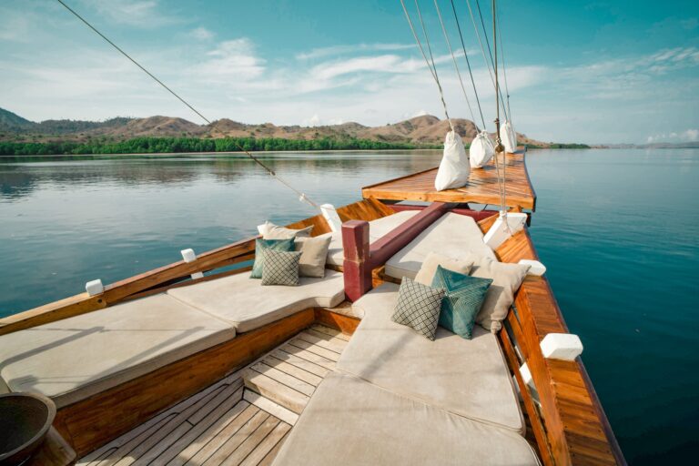 Vinca Voyage bow deck lounge with cushions overlooking a calm bay