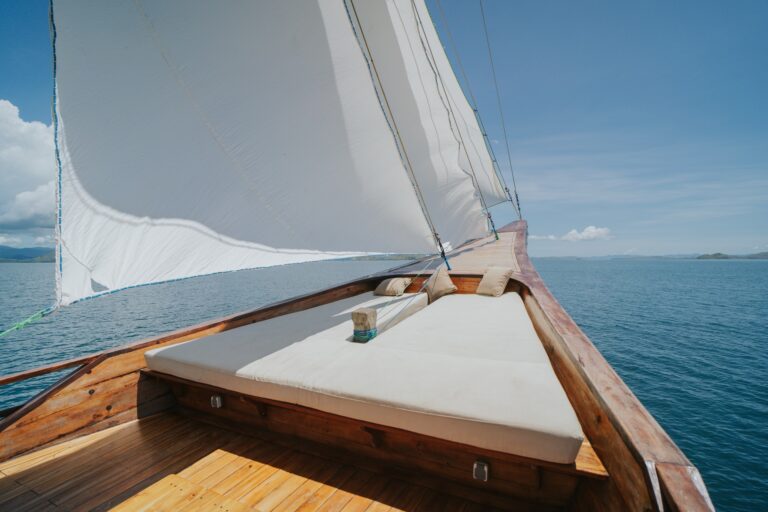 Zada Nara's bow daybed cushion beneath the mainsail with open ocean ahead