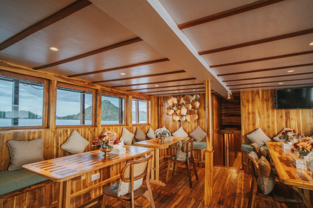 Zada Nara's dining salon with polished timber walls and teal cushioned bench seating