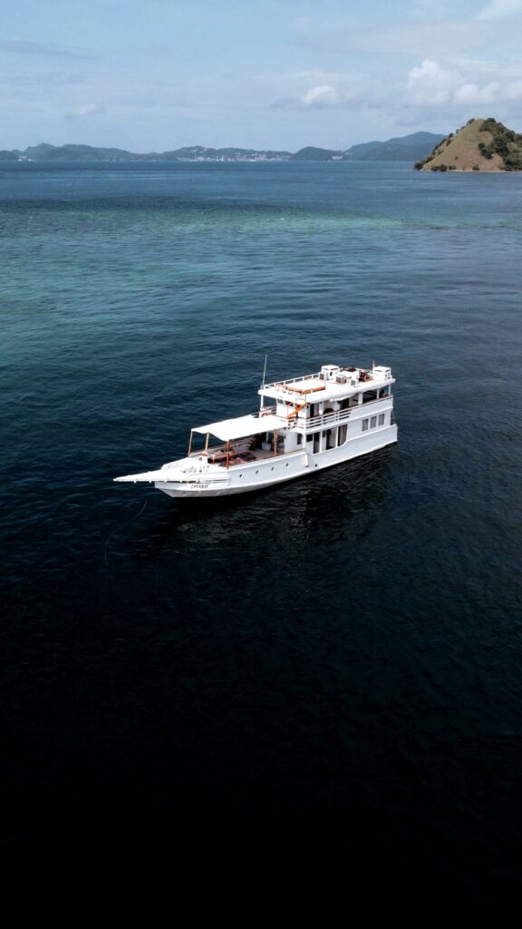 Zendaya komodo liveaboard viewed from above, white hull against Komodo's outer islands