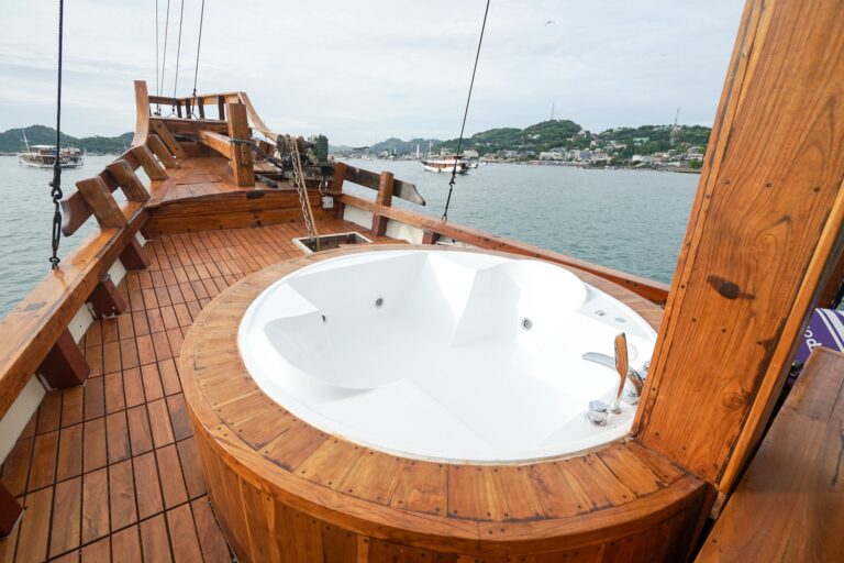 Carnaby I's round wooden-rimmed jacuzzi on the front deck overlooking the harbor