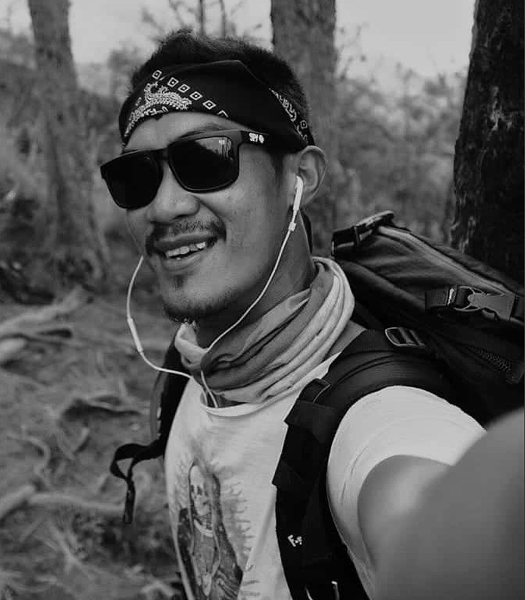 Erick, Pirate Journey co-founder, in a bandana and sunglasses, black and white selfie