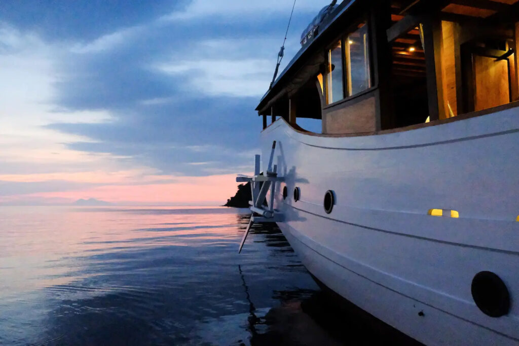 Jakare bow at dusk with warm lit cabin windows