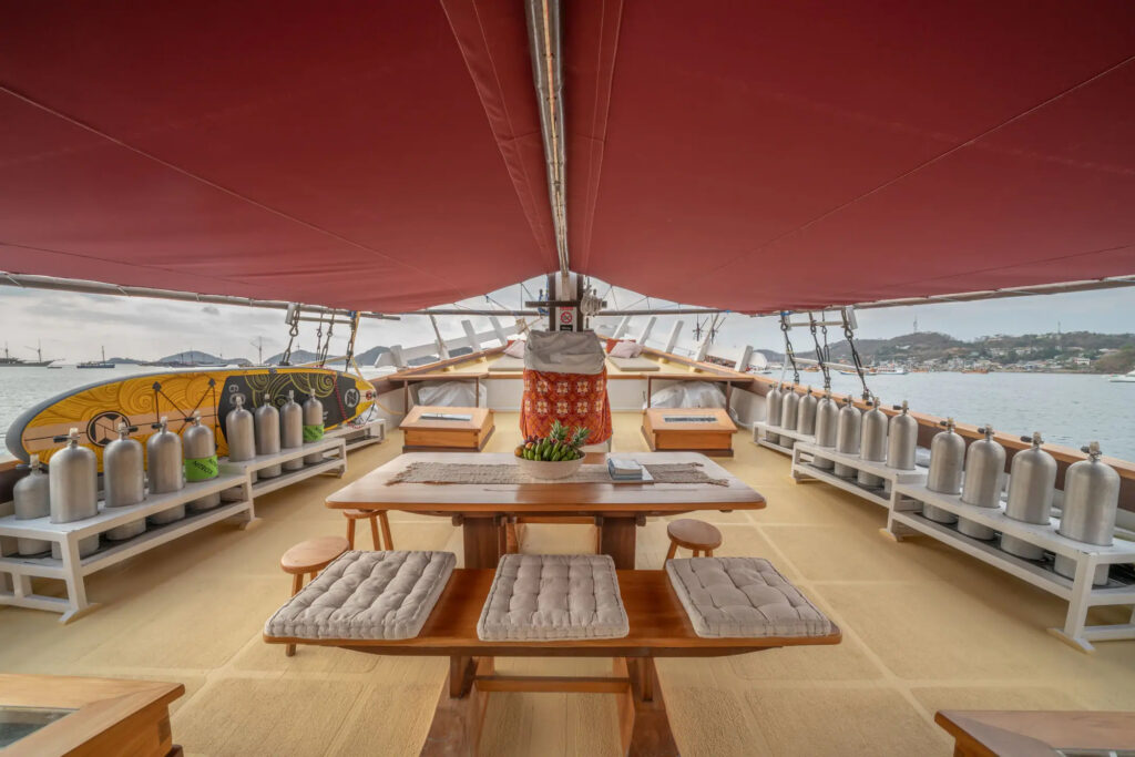 Dive deck with scuba tanks lined up and dining table