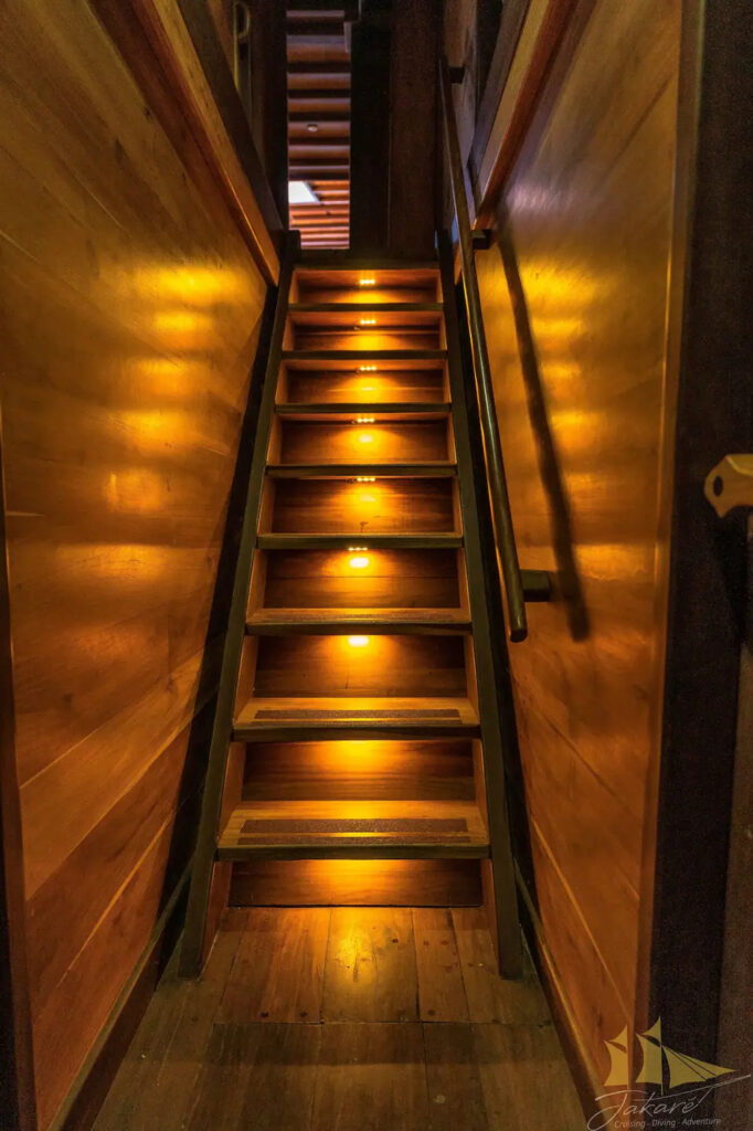 Wood interior stairwell lit by small step lights at night