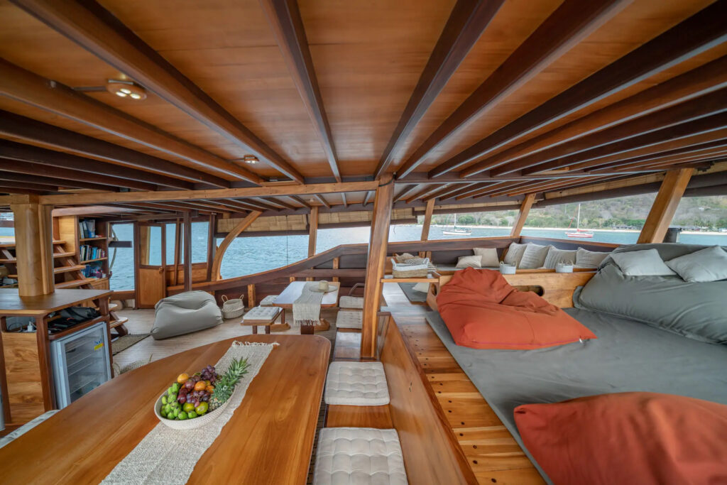 Indoor lounge and dining area with wood beams and cushions