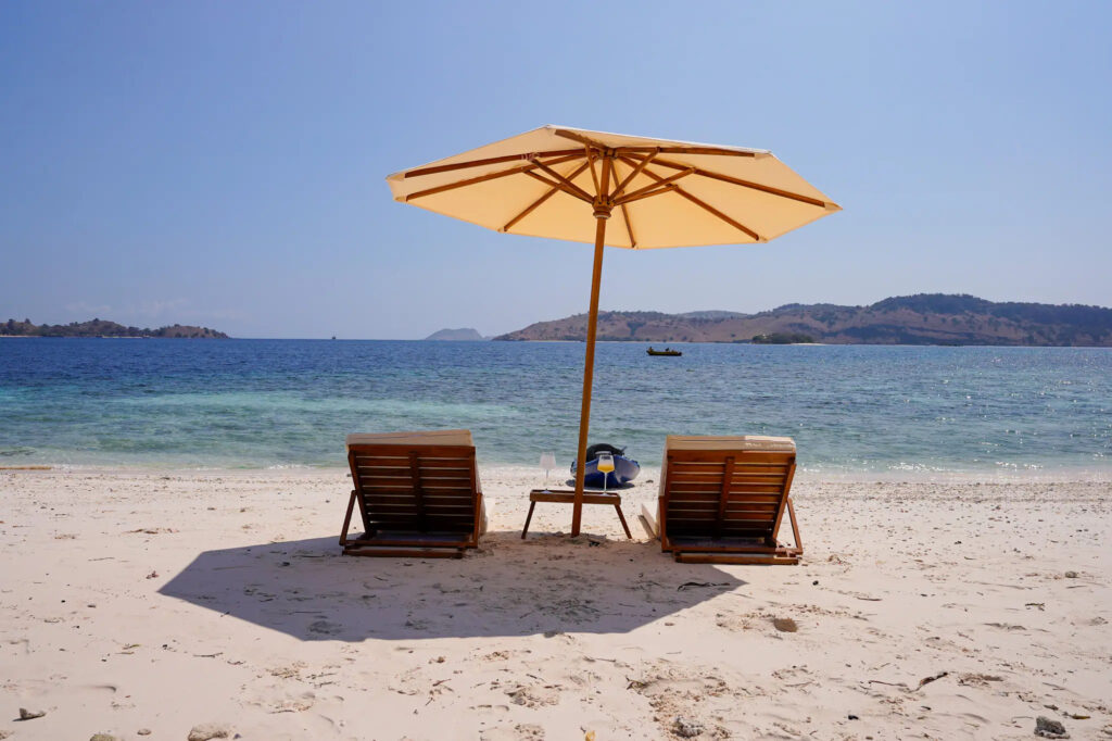 Beach loungers under an umbrella set up for Kayra guests