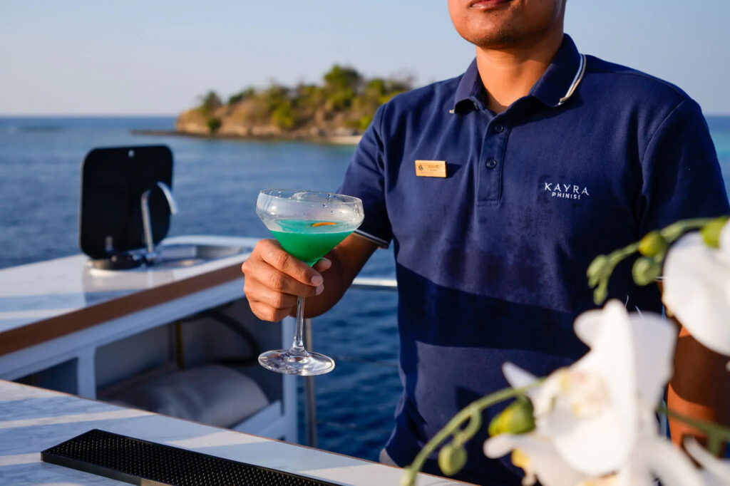 Cocktail being finished at the bar aboard Kayra