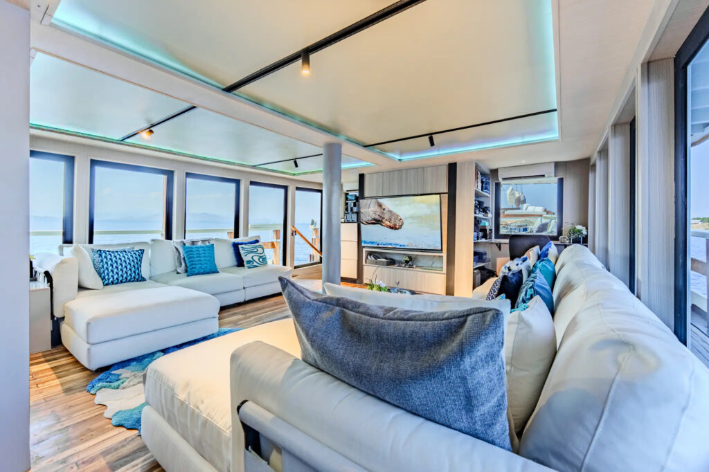 Sectional sofa facing a screen in the Kayra indoor lounge