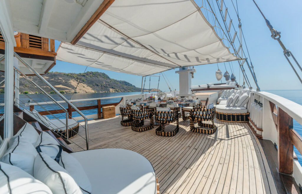 Shaded deck dining area aboard the Kayra phinisi