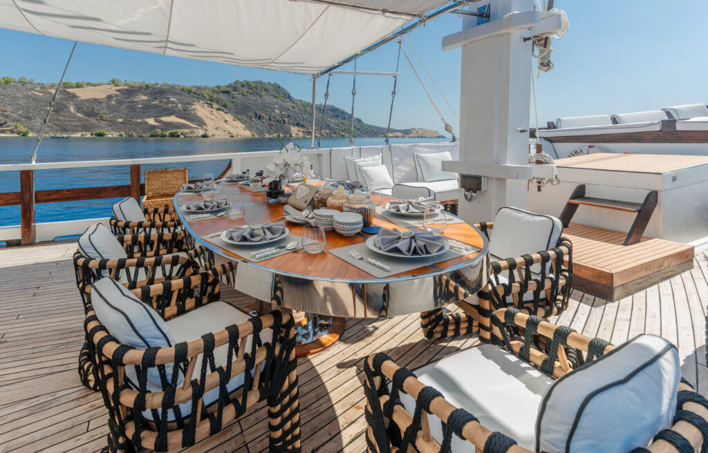 Dining table under a shade sail on the Kayra deck