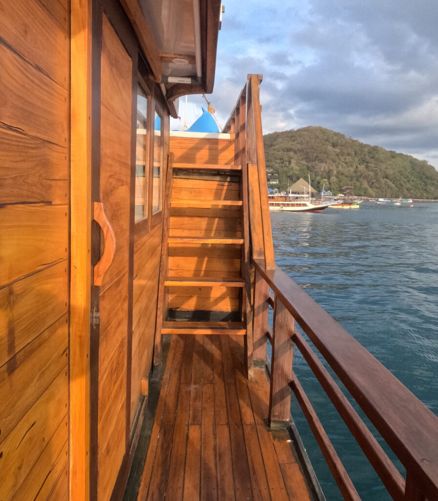 Side deck wooden stairway leading up with the harbor town beyond