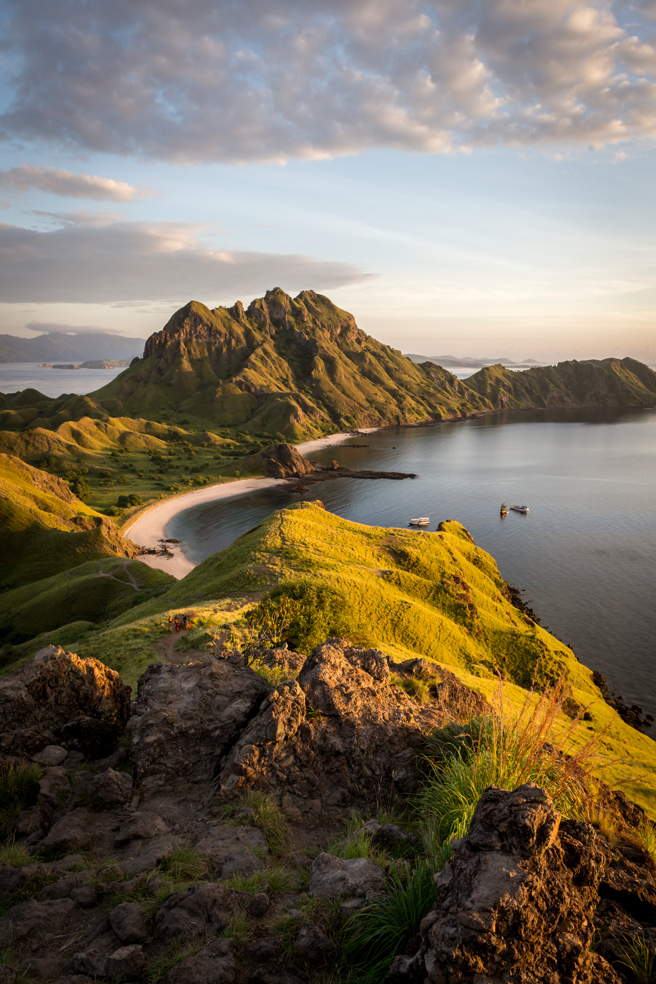 Padar Island ridge and curved bays lit by low sunrise light from the summit