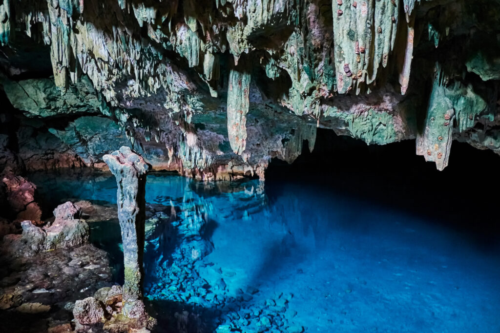 Blue saltwater pool and stalactites inside Rangko Cave north of Labuan Bajo